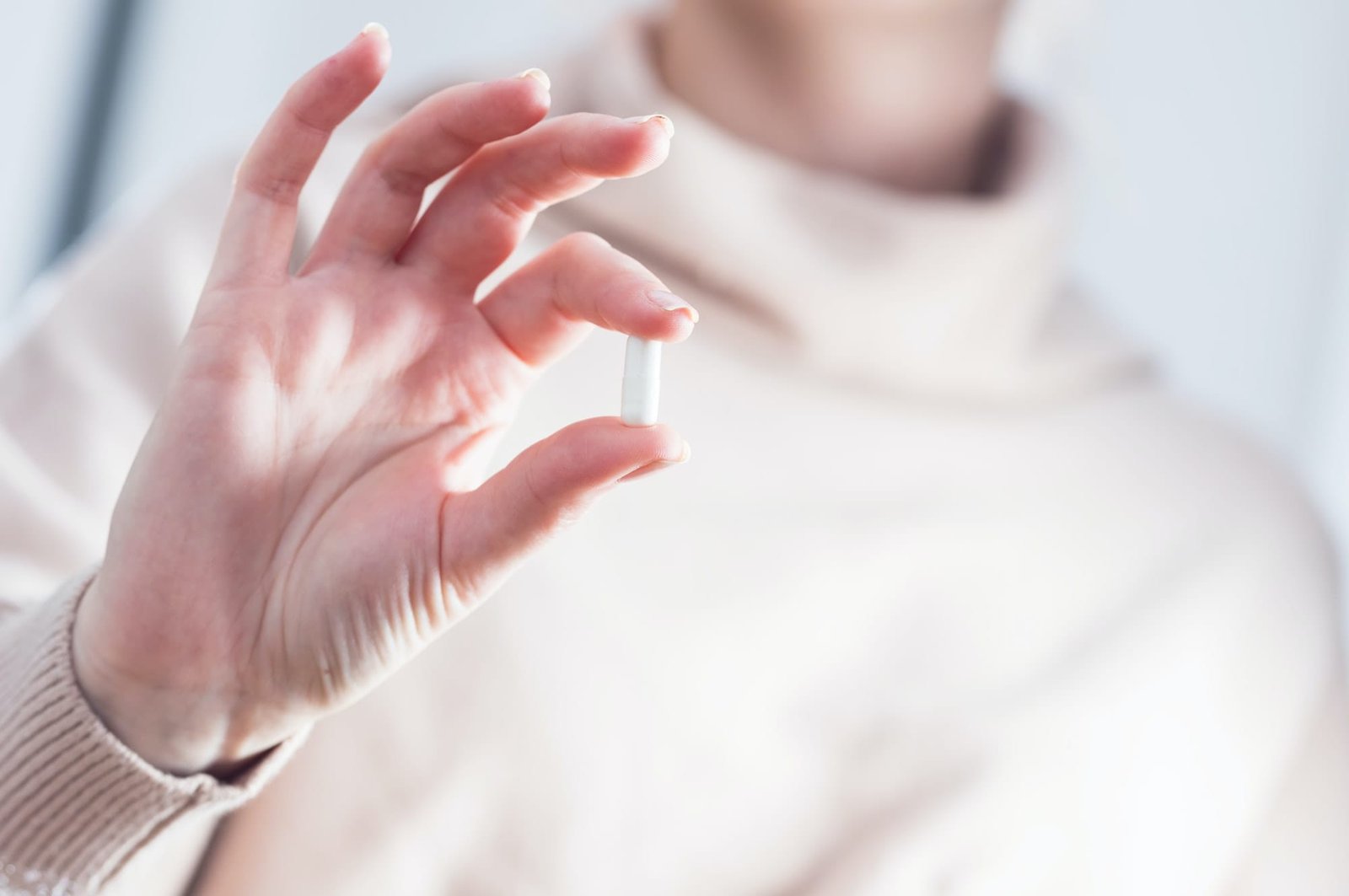 Woman holding a pill. Treatment, drug